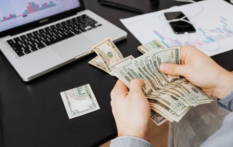 counting twenty dollar bills for the global wage hike