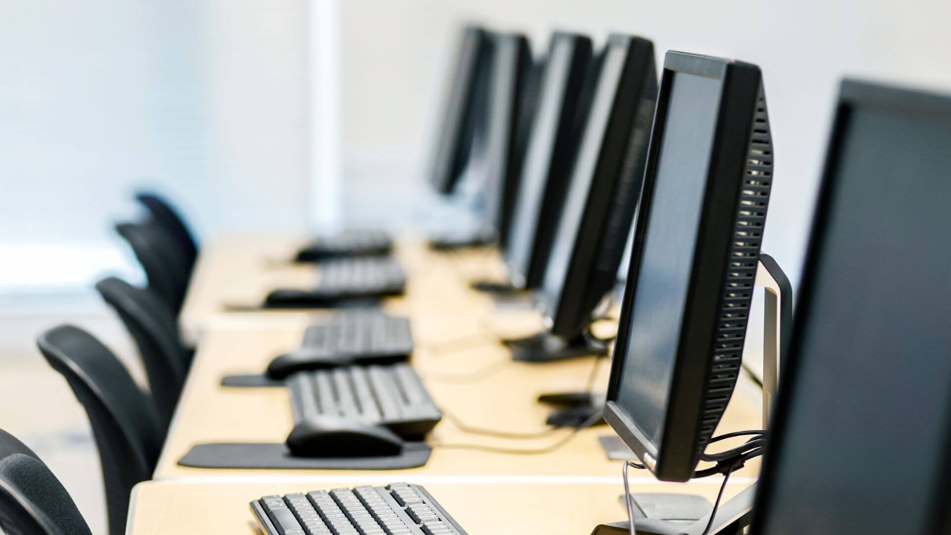 An image of office computers that need moving as part of an office relocation.