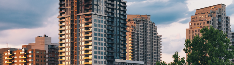 Modern Apartment Buildings Among Trees at Sunset