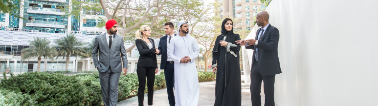 A multicultural business team talking about business on a walk in Dubai