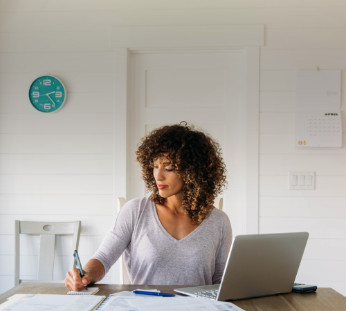 A woman who has just recently relocated overseas, reviewing her expenses from her global relocation